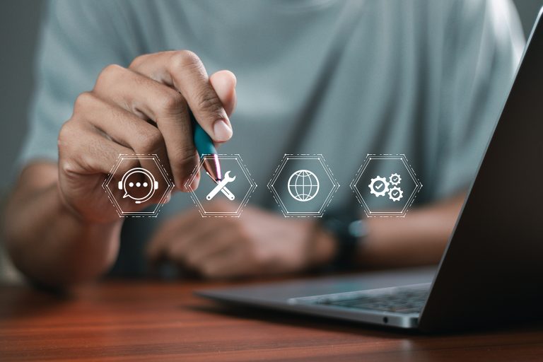 A man holding a stylus points at superimposed icons representing areas of proactive IT support.